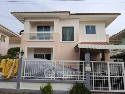 Charming two-story house with modern design and gated entrance in a serene neighborhood.