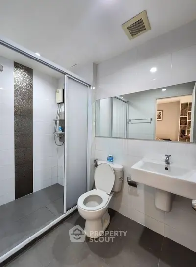 Modern bathroom with sleek shower and contemporary fixtures in a stylish apartment.