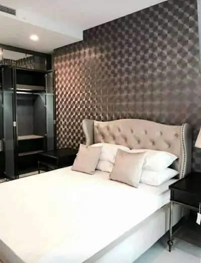 Luxurious bedroom with elegant tufted headboard and modern textured wall design