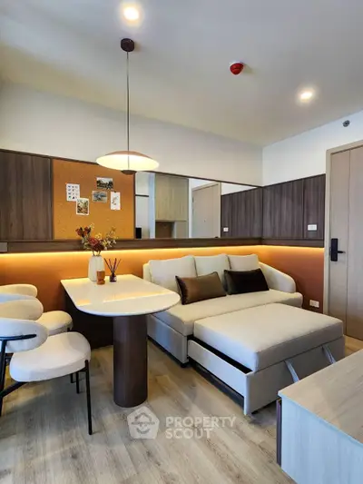 Modern living room with stylish furniture and warm lighting, perfect for cozy gatherings.