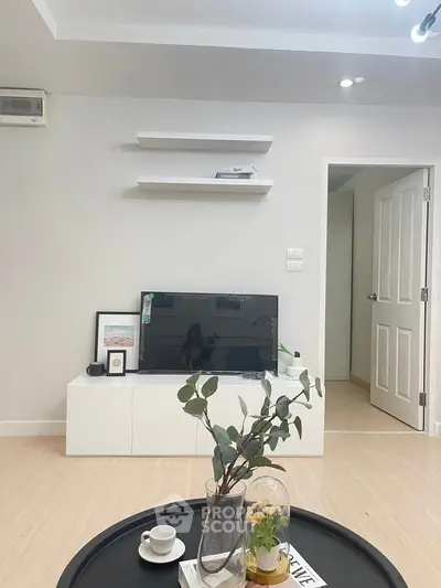 Modern living room with minimalist decor and sleek TV setup