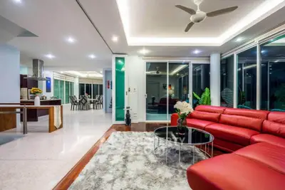 Luxurious modern living room with red leather sofa and open layout