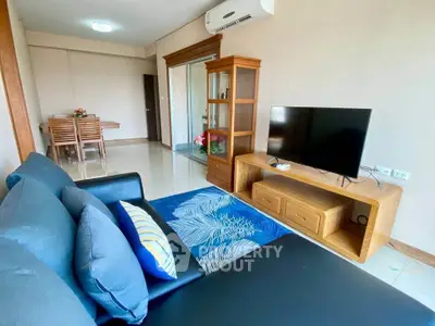 Spacious living room with modern furniture and sleek TV setup