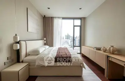 Luxurious bedroom with city view, modern furnishings, and elegant decor in high-rise apartment.