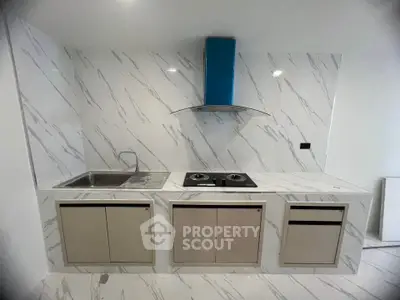 Modern kitchen with sleek marble backsplash and gas stove