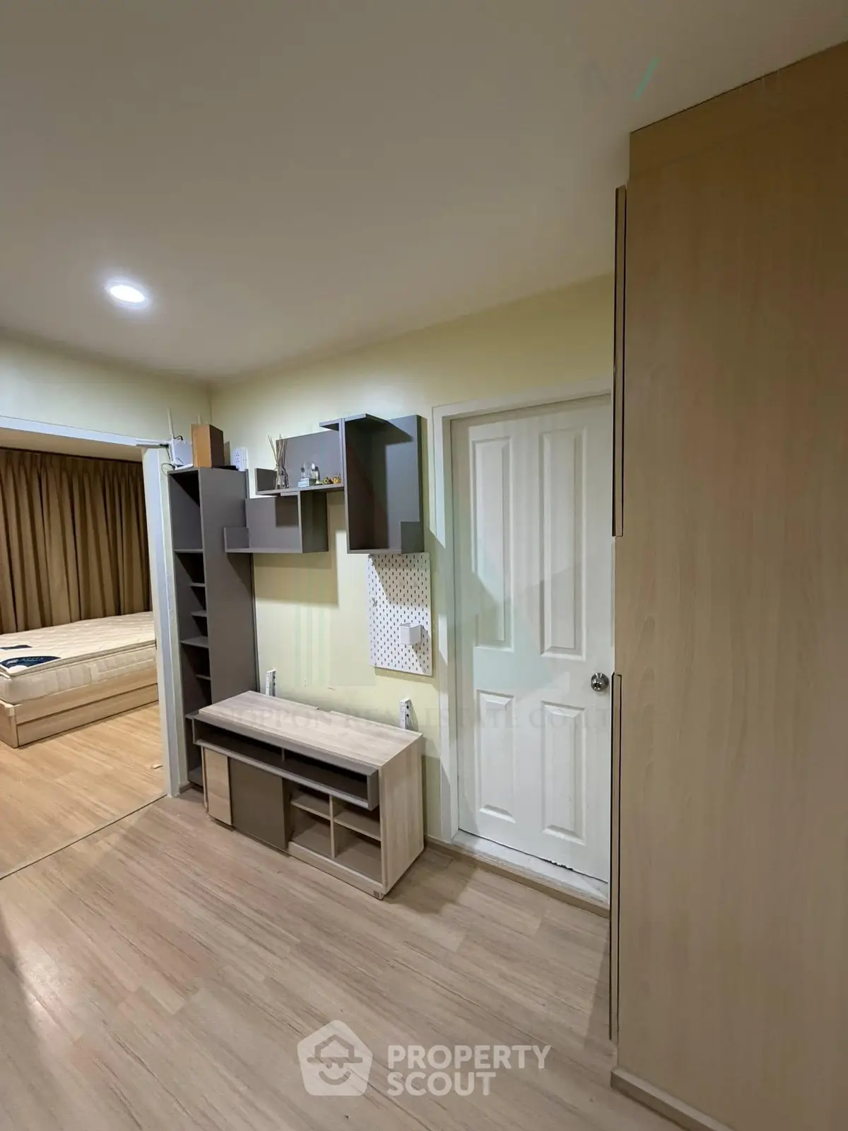 Modern bedroom with wooden flooring and built-in storage solutions