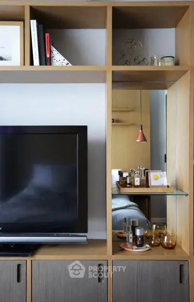 Stylish living room with modern shelving and TV setup, perfect for contemporary urban living.