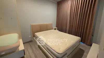 Spacious bedroom with modern design and large window for natural light.