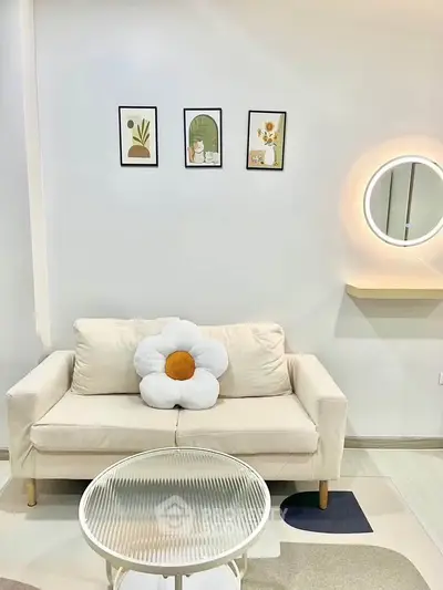 Chic living room with modern decor, featuring a cozy sofa and stylish wall art.