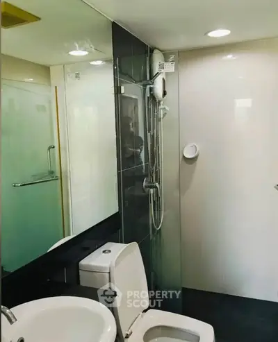 Modern bathroom with sleek fixtures and glass shower enclosure