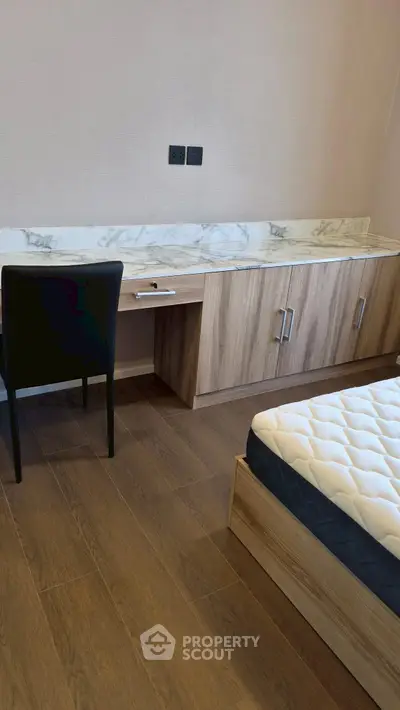 Modern bedroom with stylish wooden furniture and comfortable mattress