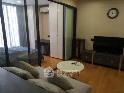 Modern studio apartment with glass partition and cozy living area