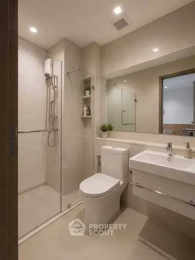 Modern bathroom with glass shower, sleek fixtures, and large mirror in a contemporary home.