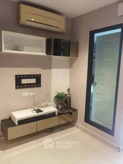 Modern living room with sleek storage and air conditioning unit, ideal for contemporary urban living.