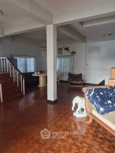 Spacious living room with wooden flooring and cozy seating area