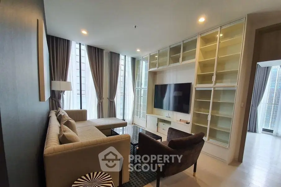 Spacious modern living room with large windows and built-in shelving