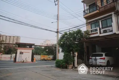 Charming residential street view with parked car and lush greenery, perfect for urban living.