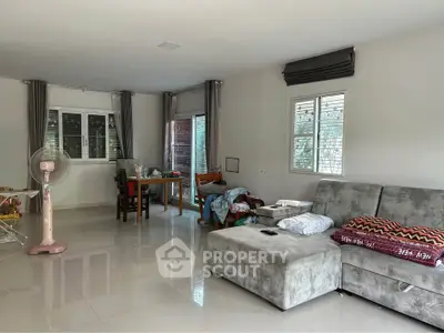 Spacious living room with modern furniture and large windows for natural light.