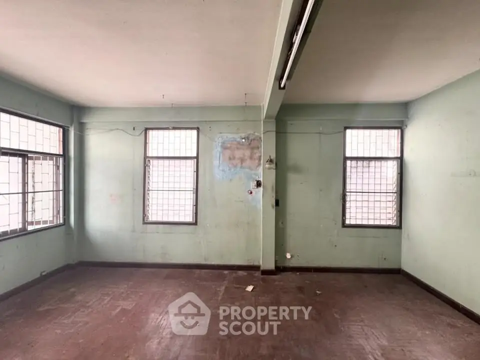 Spacious empty room with large windows and natural light, ideal for customization.