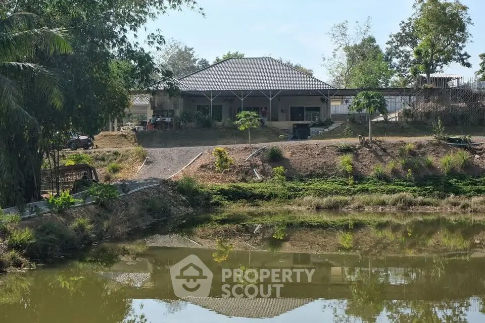 Charming lakeside property with lush greenery and serene views, perfect for tranquil living.