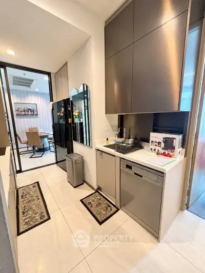 Modern kitchen with sleek cabinetry and integrated appliances in a stylish apartment.