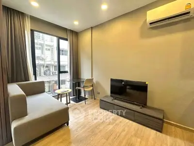 Modern living room with sleek furniture and large window offering city view