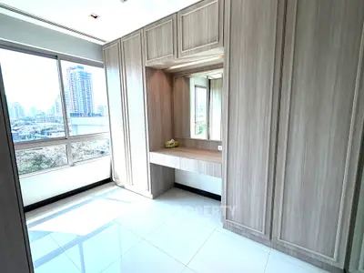 Spacious modern bedroom with built-in wardrobe and city view