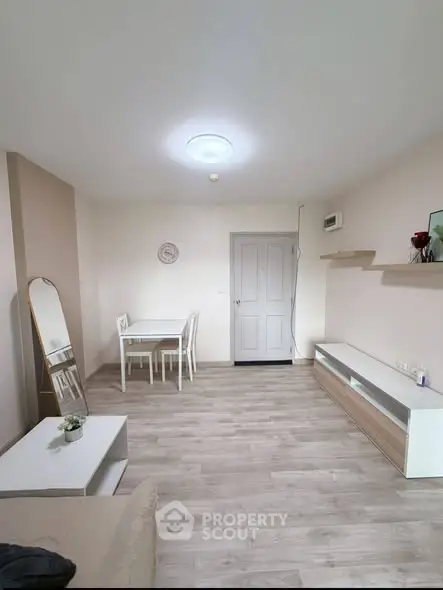 Bright and modern living room with stylish furniture and wooden flooring.