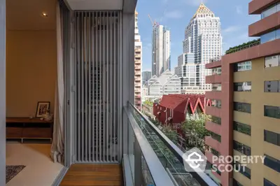 Modern city view from a stylish apartment balcony with glass railing