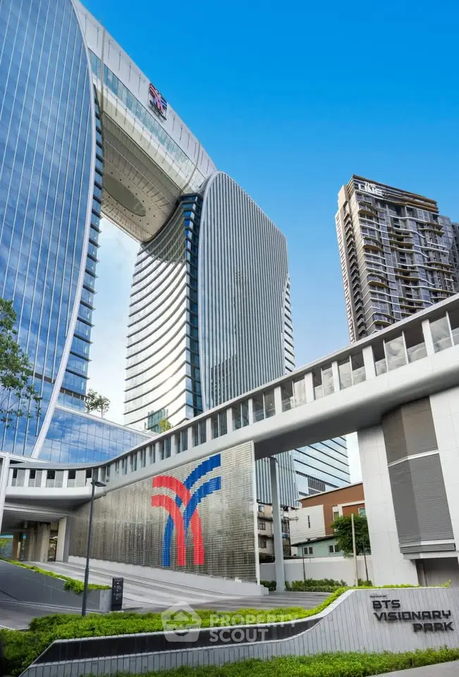Stunning modern architecture of BTS Visionary Park with sleek glass facade and lush landscaping.