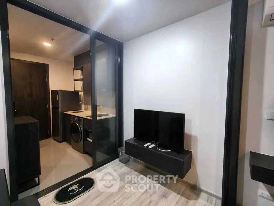 Modern apartment interior with sleek kitchen and cozy living area