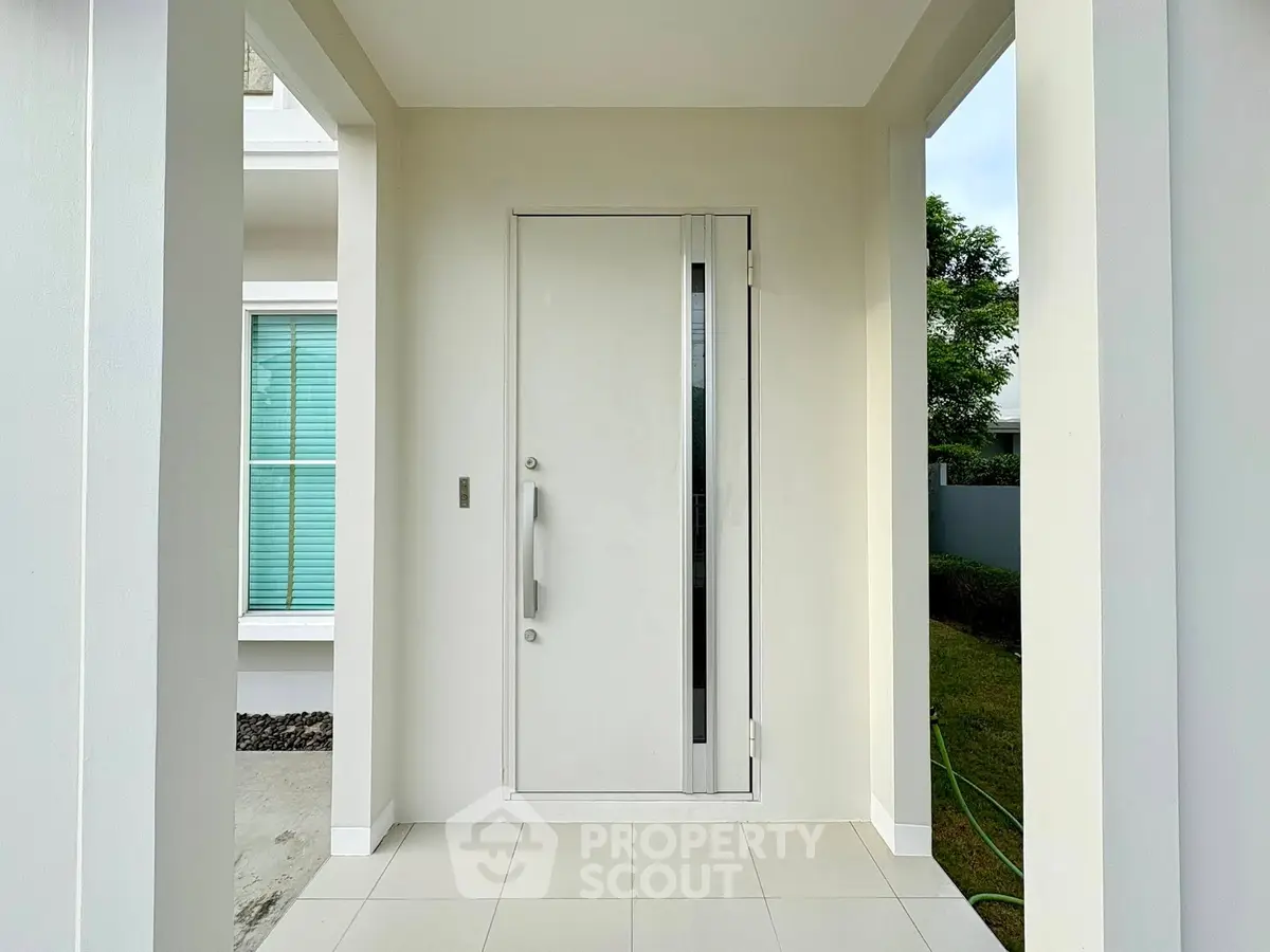 Modern entrance with sleek white door and minimalist design, perfect for contemporary homes.