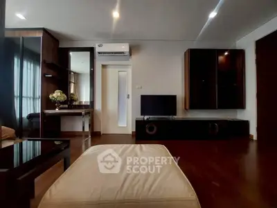 Modern living room with sleek furniture and air conditioning, featuring a cozy ambiance and stylish decor.