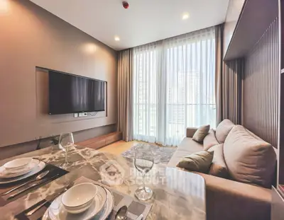 Modern living room with elegant decor and large windows offering city views.