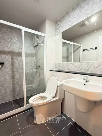Modern bathroom with sleek shower enclosure and contemporary fixtures.