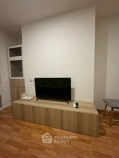Modern living room with sleek TV stand and wooden flooring