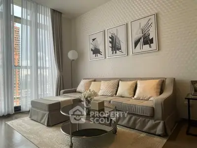 Elegant living room with modern decor and large window offering city views.