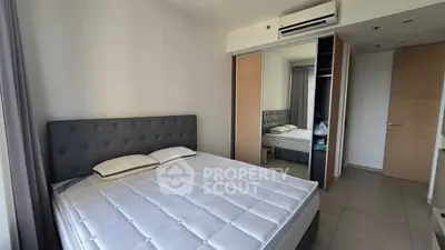 Spacious bedroom with modern design and ample closet space in a stylish apartment.