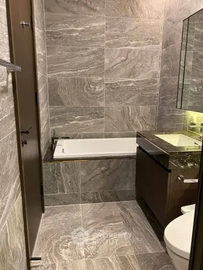 Luxurious modern bathroom with elegant stone tiles and sleek fixtures