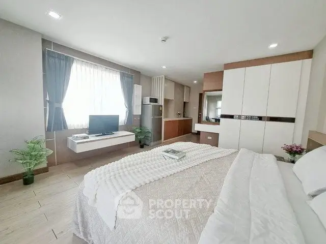 Spacious modern bedroom with elegant decor and natural light