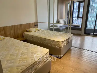 Spacious bedroom with twin beds and large windows in modern apartment