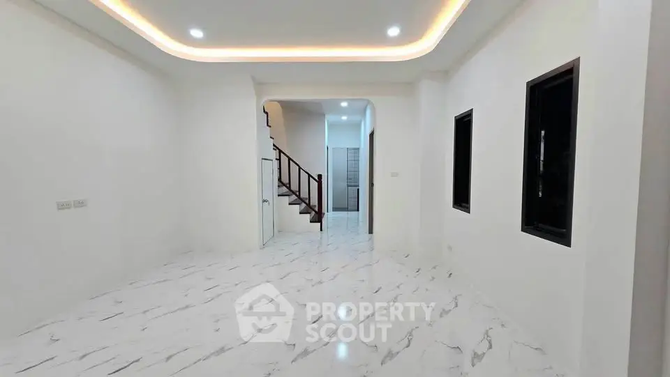 Spacious modern interior with marble flooring and elegant lighting, perfect for stylish living.
