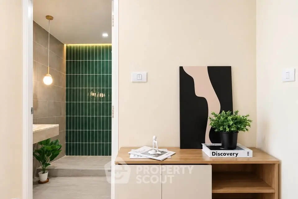 Modern interior with stylish decor and bathroom view, featuring elegant lighting and contemporary design.