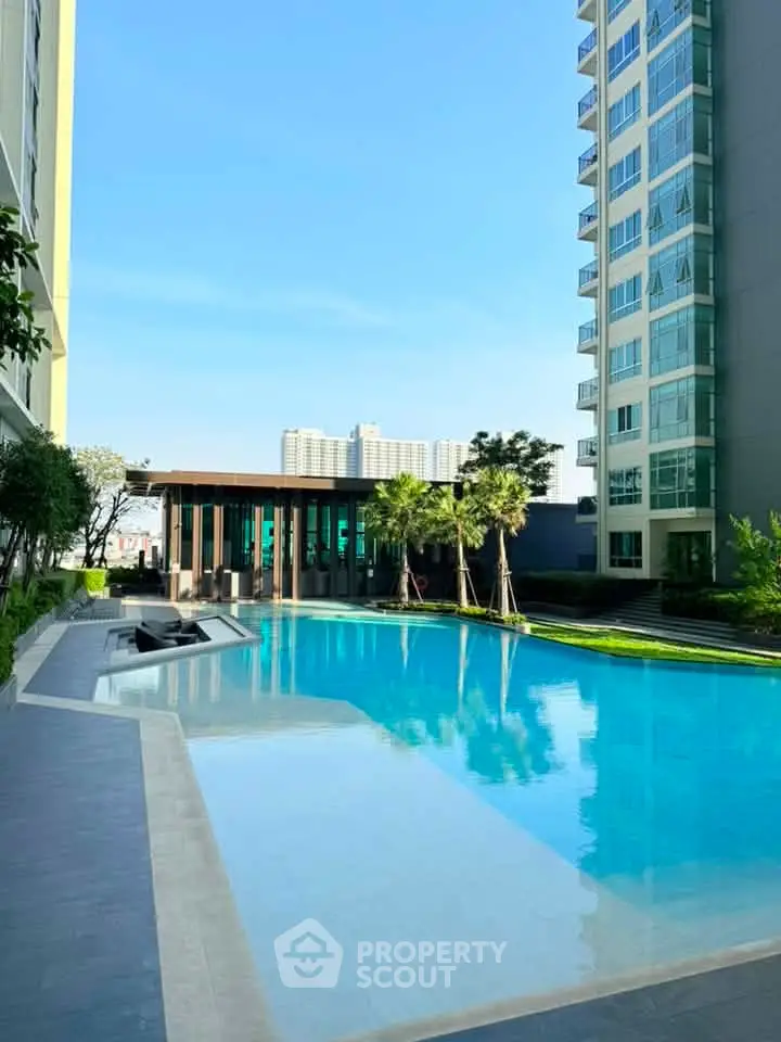 Luxurious condominium with stunning pool and modern architecture, perfect for urban living.