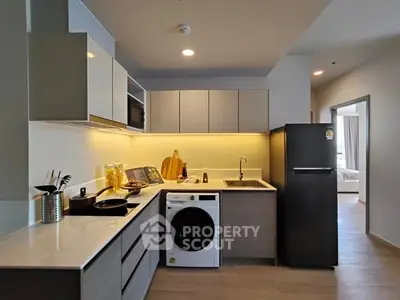 Modern kitchen with sleek cabinetry, integrated appliances, and ambient lighting.