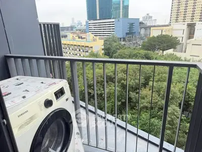Modern balcony with washing machine and city view, ideal for urban living.