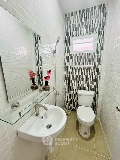 Modern compact bathroom with stylish tile design and sleek fixtures.