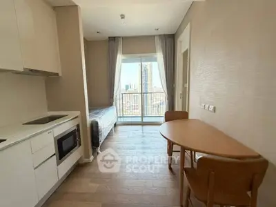 Modern studio apartment with open kitchen and city view balcony