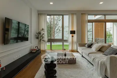 Luxurious living room with modern decor and large windows