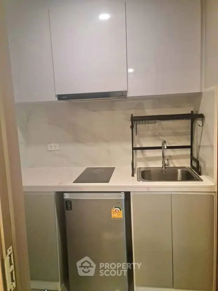 Modern compact kitchen with sleek cabinets and stainless steel appliances